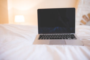 Mac computer on a bed